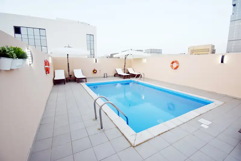 A 2-bedroom furnished apartment with shared pool, gym, and parking